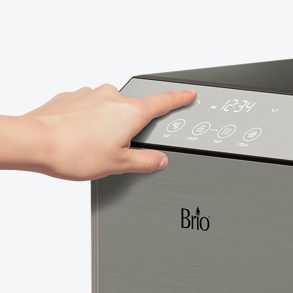 A hand touches the digital control panel of a Brio appliance, displaying icons and a digital time reading of 12:34.